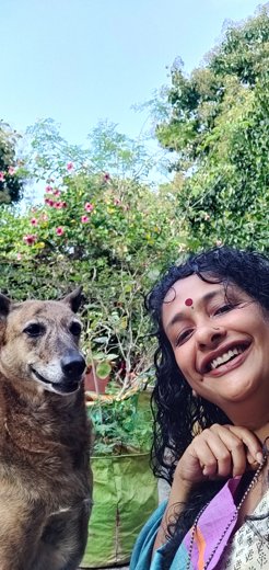 Sindhoor Pangal in a garden with a dog